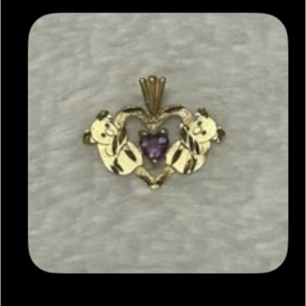 Vintage 14 kt gold pendant with 2 bears and small purple stone.Marked 14k